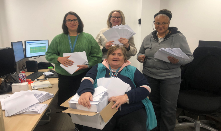 Colleagues sending out vouchers to customers